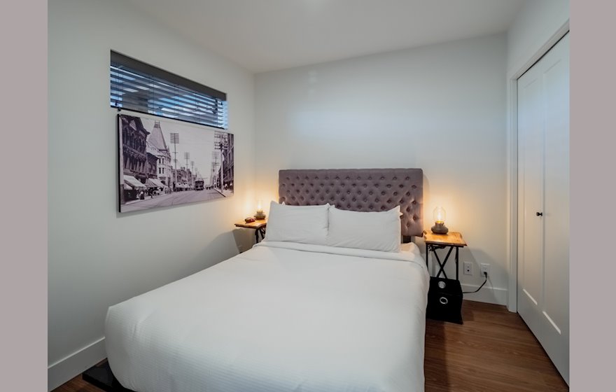 Ironworks 418 fully furnished bedroom with a TVVictoria